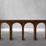Wooden console table with arch designs on a gray background