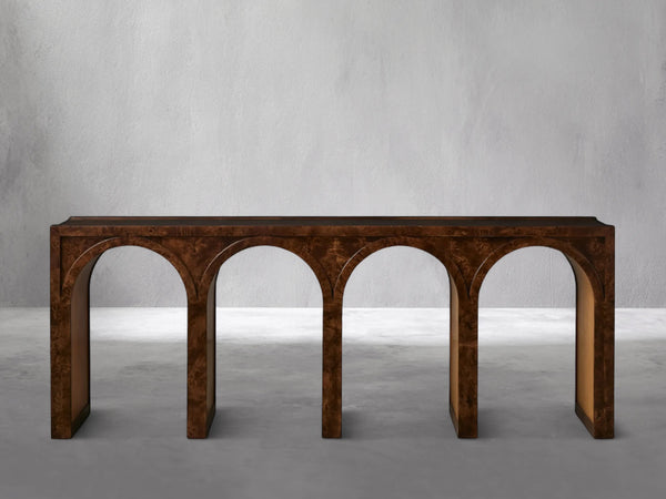Wooden console table with arch designs on a gray background