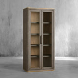 Tall wooden cabinet with glass doors against a gray concrete wall.