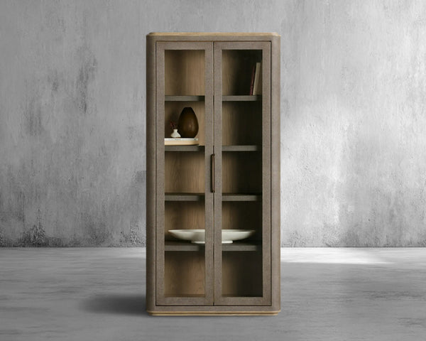 Wooden cabinet with glass doors against a gray concrete wall.