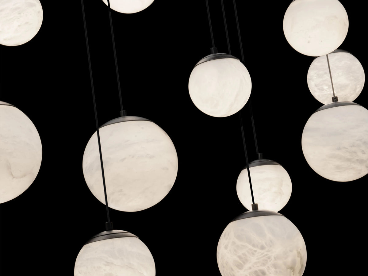 Chandelier with multiple round light bulbs against a black background